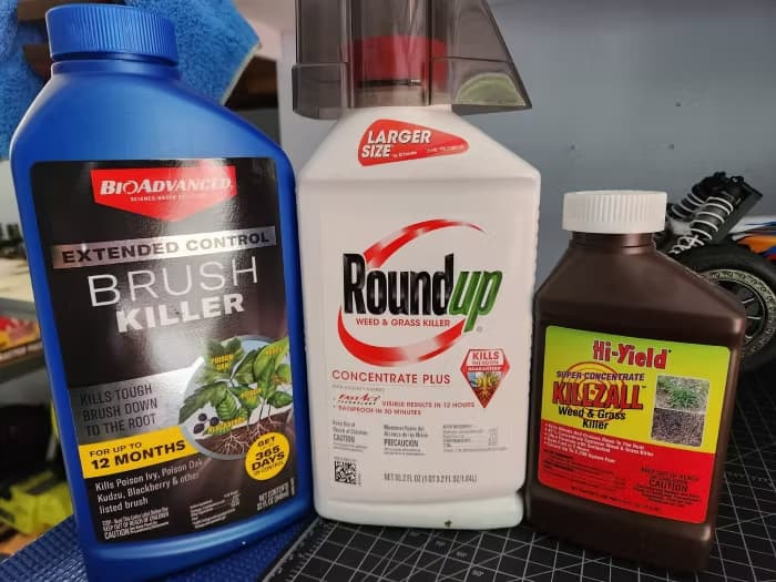 Three weed-killer concentrates — a BioAdvanced brush killer advertising up to 12 months of control, Roundup Concentrate Plus, and Hi-Yield Killzall.