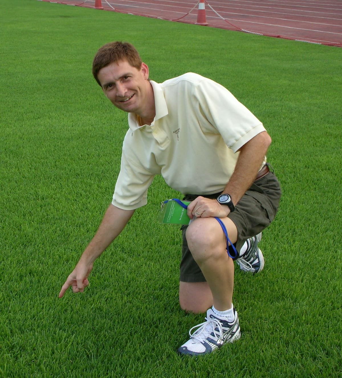 Grady Miller kneeling in a turfgrass research plot